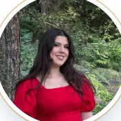 Elizabeth Nikolova, in a red dress in a forest