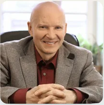 Professor Konstantin Korotkov, seated with his hands clasped